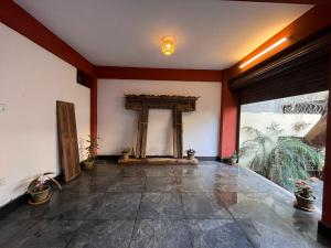 an empty room with a pillar and a large window at Mandāravā Āvāsa in Kathmandu