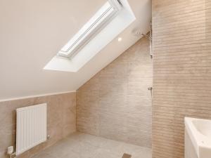 a bathroom with a shower and a skylight at 4 Bed in Dunstable oc-93632 in Totternhoe +23 photos