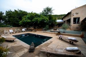 a backyard with a swimming pool and a house at The Nutcracker Homestead in Venterskroon