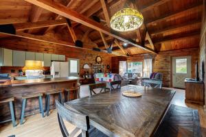a dining room and kitchen with a table and chairs at 4-Season Family Base! 13 Mi to Lake Winnipesaukee in Center Barnstead
