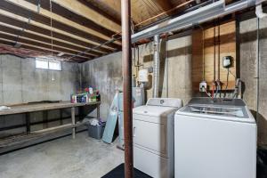a laundry room with a washing machine and a counter at 4-Season Family Base! 13 Mi to Lake Winnipesaukee in Center Barnstead +31 photos