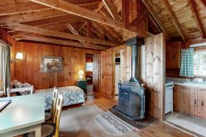 a living room with a woodburning stove in a cabin at Bay-View Getaway w/ Deck Between Camden & Belfast! in Northport