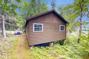 a small cabin in the woods with a car parked at Bay-View Getaway w/ Deck Between Camden & Belfast! in Northport +8 photos