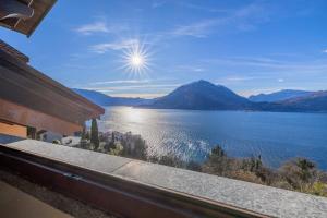 a view from a balcony of a lake and mountains at Il Nido sul Lago in Perledo