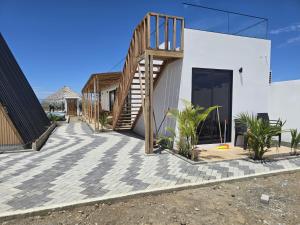a house with a staircase on the side of it at Helite Arena y Mar in Puerto Cayo