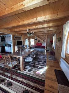 a dining room with a table and chairs in a cabin at Casa Dani in Vatra Dornei