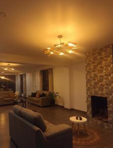 a living room with a couch and a fireplace at Casa Blanca Andina in Cajamarca