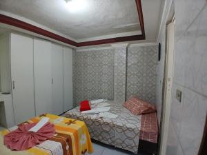 a small room with two beds in it at Aconchego de Olinda in Olinda