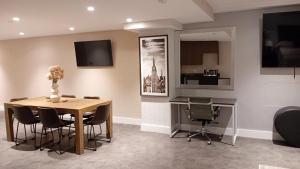 a dining room with a table and chairs and a desk at Rose Hotel Near Yankee Stadium in Bronx