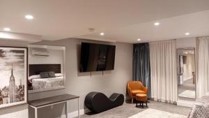 a bedroom with a bed and a tv on the wall at Rose Hotel Near Yankee Stadium in Bronx
