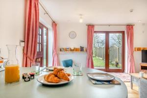 a table with a plate of croissants and orange juice at 2 Bed in Barnby oc-t28265 in North Cove