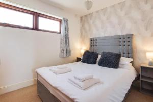 a bedroom with a large white bed with two pillows at 2 Bed in Barnby oc-t28265 in North Cove