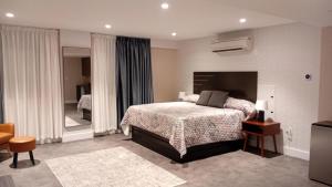 a bedroom with a bed and a large mirror at Rose Hotel Near Yankee Stadium in Bronx