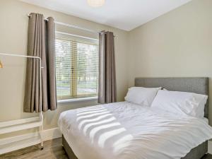 a bedroom with a large white bed with a window at 2 Bed in Kings Lynn oc-96048 in Middleton