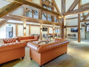 a large room with leather furniture and wooden ceilings at 2 Bed in Kings Lynn oc-96048 in Middleton