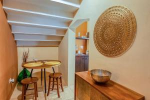 a kitchen with a table and stools in a room at Corte Piri in Tricase