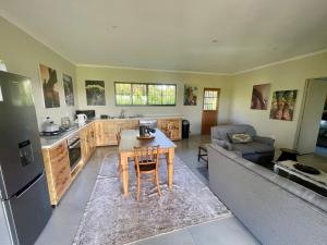 a kitchen and living room with a table and a couch at Pecan Tree Haven in Winterton +12 photos