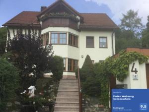 a large white house with stairs in front of it at Ferien Wohnung Sonnenschein in Wechterswinkel