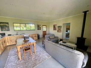 a living room with a couch and a table at Pecan Tree Haven in Winterton