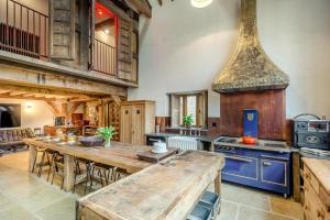 a large kitchen with a wooden table and a stove at 5 Bed in Kings Lynn oc-96250 in Clenchwarton