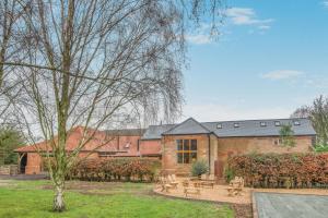 a brick building with a picnic table in a yard at 5 Bed in Kings Lynn oc-96250 in Clenchwarton
