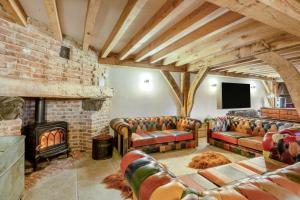 a living room with couches and a brick wall at 5 Bed in Kings Lynn oc-96250 in Clenchwarton