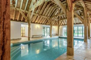 an indoor swimming pool with a wooden ceiling at 5 Bed in Kings Lynn oc-96250 in Clenchwarton