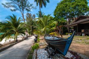a boat sitting on the side of a road at Perhentian Island Resort in Perhentian Islands