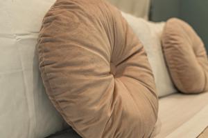 a person sitting on a couch with their head on a pillow at Palazzo Margò - Private Luxury Palace with Sea View in Mola di Bari
