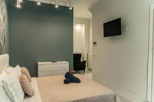 a bedroom with a bed with a teddy bear on it at Palazzo Margò - Private Luxury Palace with Sea View in Mola di Bari