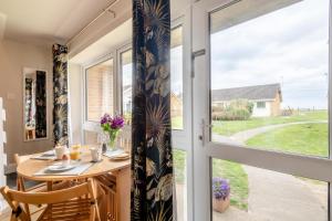 a dining room with a table and a window at 3 Bed in Corton oc-s32347 in Corton