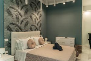 a bedroom with a bed with two pillows on it at Palazzo Margò - Private Luxury Palace with Sea View in Mola di Bari