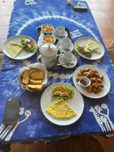 a blue table with plates of food on it at Résidence Keur Fleurie in Toubab Dialaw