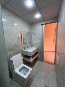 a bathroom with a toilet and a sink at Wadi rum camp teem in Wadi Rum
