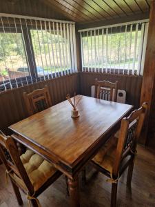 a wooden table and chairs in a room at Cabin Retreat in Trawsfynydd