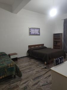 a bedroom with a bed and a dresser at Bella Reggio in Reggio di Calabria