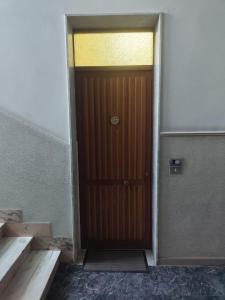 a wooden door in a room with stairs at Bella Reggio in Reggio di Calabria