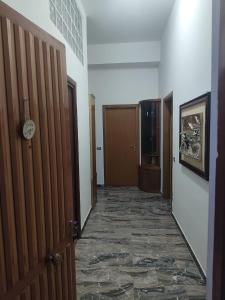 a corridor of a hallway with a door and a television at Bella Reggio in Reggio di Calabria