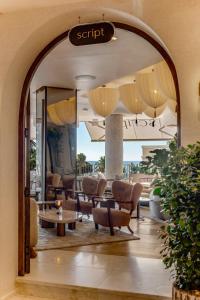 an archway in a lobby with chairs and a table at The Cole Boutique Hotel & Spa in Cape Town