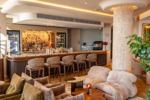 a bar in a hotel with chairs and a bar counter at The Cole Boutique Hotel & Spa in Cape Town