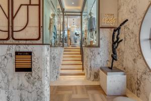 a hallway with stairs and a statue in a building at The Cole Boutique Hotel & Spa in Cape Town +66 photos