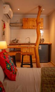 a kitchen with a table and a tree in a room at Refugio del Maipo Lodge in San José de Maipo