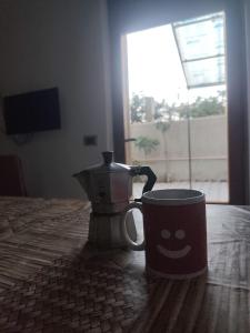 a coffee cup with a smiley face on a table at Bella Reggio in Reggio di Calabria