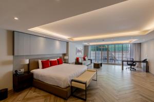 a bedroom with a large bed with red pillows at Isaaya Hotel Boutique by WTC in Mexico City