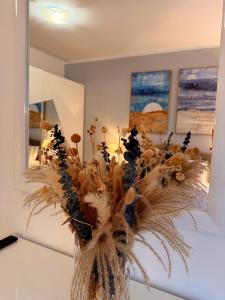 a vase filled with dried flowers on a table at Vatican luxury - private parking free - meospiti luxury in Rome
