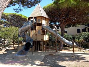 a playground with a slide and a tower at les pieds dans l'eau 1-Piscine chauffée in Le Barcarès