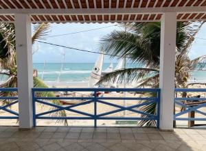 a view of the beach from the porch of a beach house at Pousada Caponga Praia Mar in Cascavel