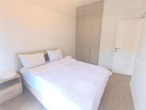 a white bed with white sheets in a bedroom at Apartment in Verin Apart hotel in Dilijan in Dilijan