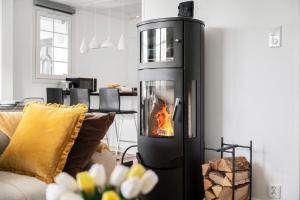 a fireplace in a living room with a fire in it at Sunset Stay in Malmö