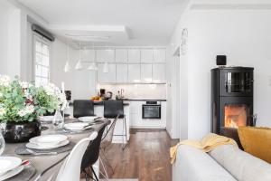 a kitchen and living room with a table and a couch at Sunset Stay in Malmö +46 photos